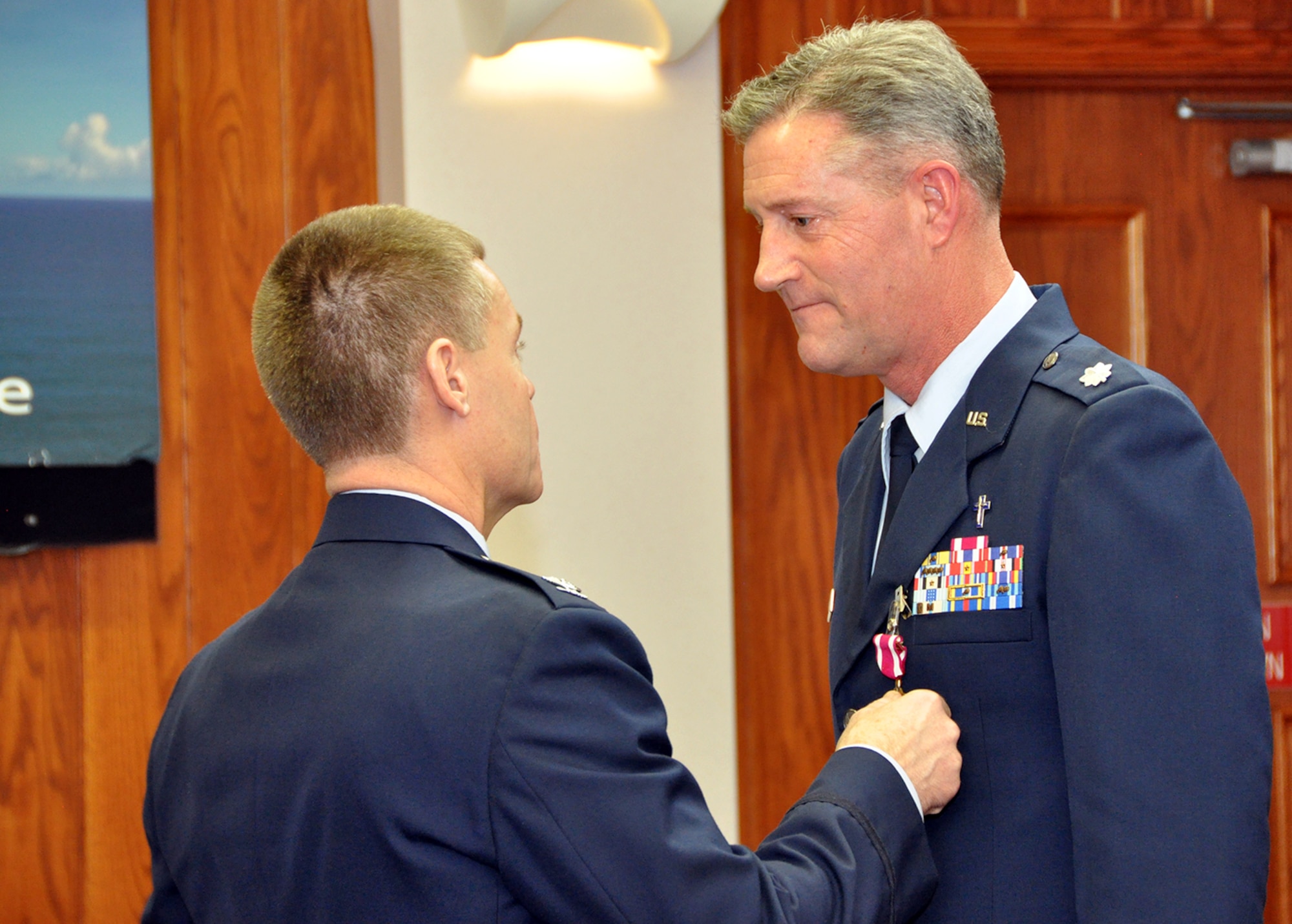 Lt. Col. William D. Davis, 911th Airlift Wing chaplain, receives the Meritorious Service Medal from 911th AW Commander Col. Craig C. Peters, during his retirement ceremony inside the chapel at the Pittsburgh International Airport Air Reserve Station, Jan 11, 2014. In addition to his traditional duty of overseeing the religious services of the 911th AW, Davis has also performed more than 100 hours of counseling, three weddings, six funerals, five casualty notifications, and one baptism since his 2001 arrival. Davis’s level of devotion and welcoming demeanor will be missed among the Airmen of the 911th AW. (U.S. Air Force photo by Senior Airman Joseph E. Bridge)