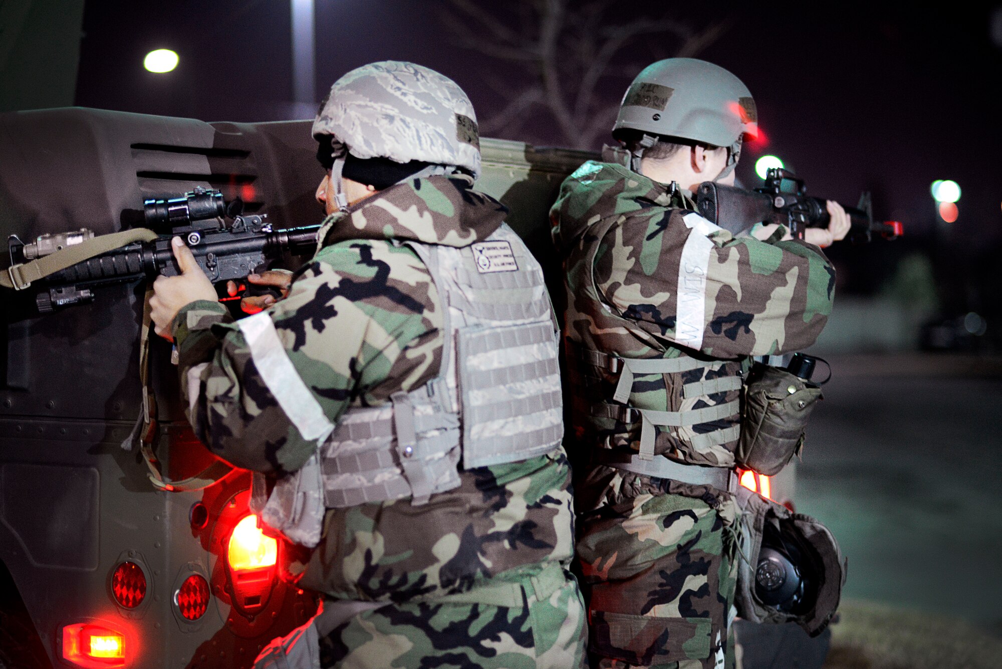 Personnel from the 51st Security Forces Squadron and 51st Communications Squadron Installation Arming and Response Team look to engage opposition forces role players during Operational Readiness Exercise Beverly Midnight 14-01 at Osan Air Base, Republic of Korea, Jan. 14, 2014. During exercises and war-time contingency operations, the IA&RT stands up to defend the 51st CS compound and all of its assets. (U.S. Air Force photo/Tech. Sgt. Micky Bazaldua)
