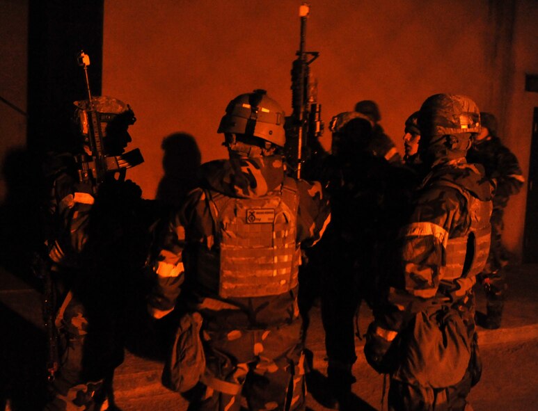 Members of the 51st Security Forces Squadron discuss tactics during Operational Readiness Exercise Beverly Midnight 14-01 at Osan Air Base, Republic of Korea, Jan. 14, 2014. Defenders engaged opposition forces role players acting as enemy attackers in one of the many battle scenarios outside Bldg. 1097. (U.S. Air Force photo/Senior Airman Siuta B. Ika)