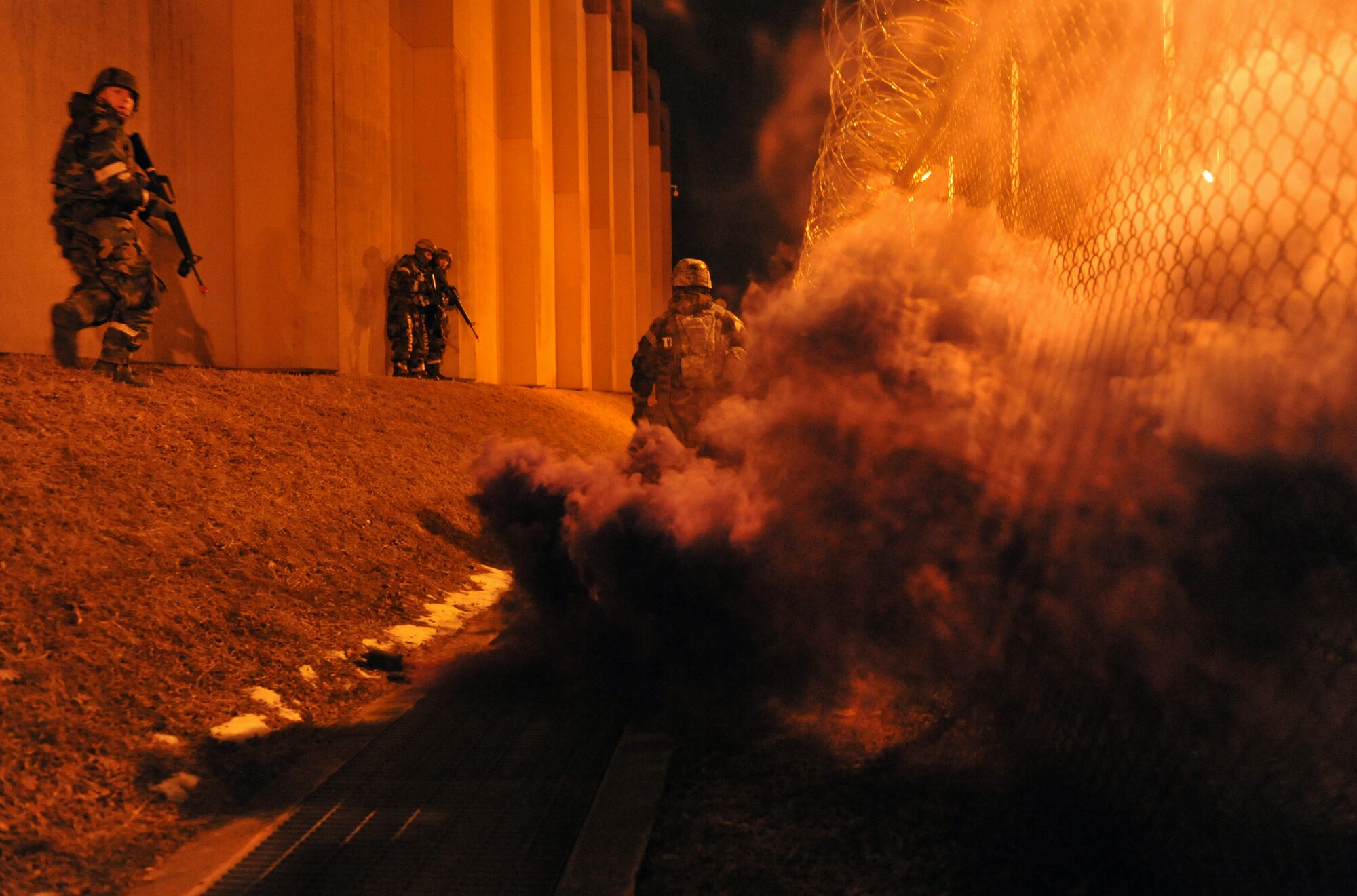 Members of the 51st Security Forces Squadron move towards opposition forces role players during a ground attack during Operational Readiness Exercise Beverly Midnight 14-01 at Osan Air Base, Republic of Korea, Jan. 14, 2014. Scenarios like this give Airmen a chance to hone wartime skills in a safe and structured environment in preparation for real-world contingencies. (U.S. Air Force photo/Senior Airman Siuta B. Ika)