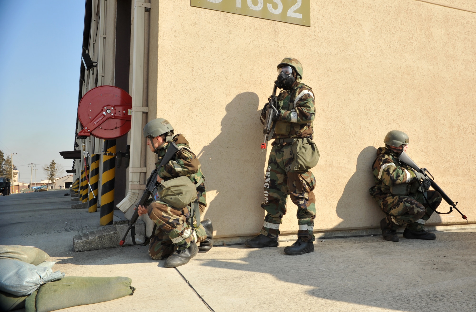 Airmen from the 51st Logistics Readiness Squadron secure their portion of the squadron’s vehicle compound after a simulated ground attack during Operational Readiness Exercise Beverly Midnight 14-01 at Osan Air Base, Republic of Korea, Jan. 14, 2014. The Airmen, along with members of the 51st Security Forces Squadron, practiced responding to an attack while wearing Mission Oriented Protective Posture Level 2 gear. (U.S. Air Force photo/Airman 1st Class Ashley J. Thum)