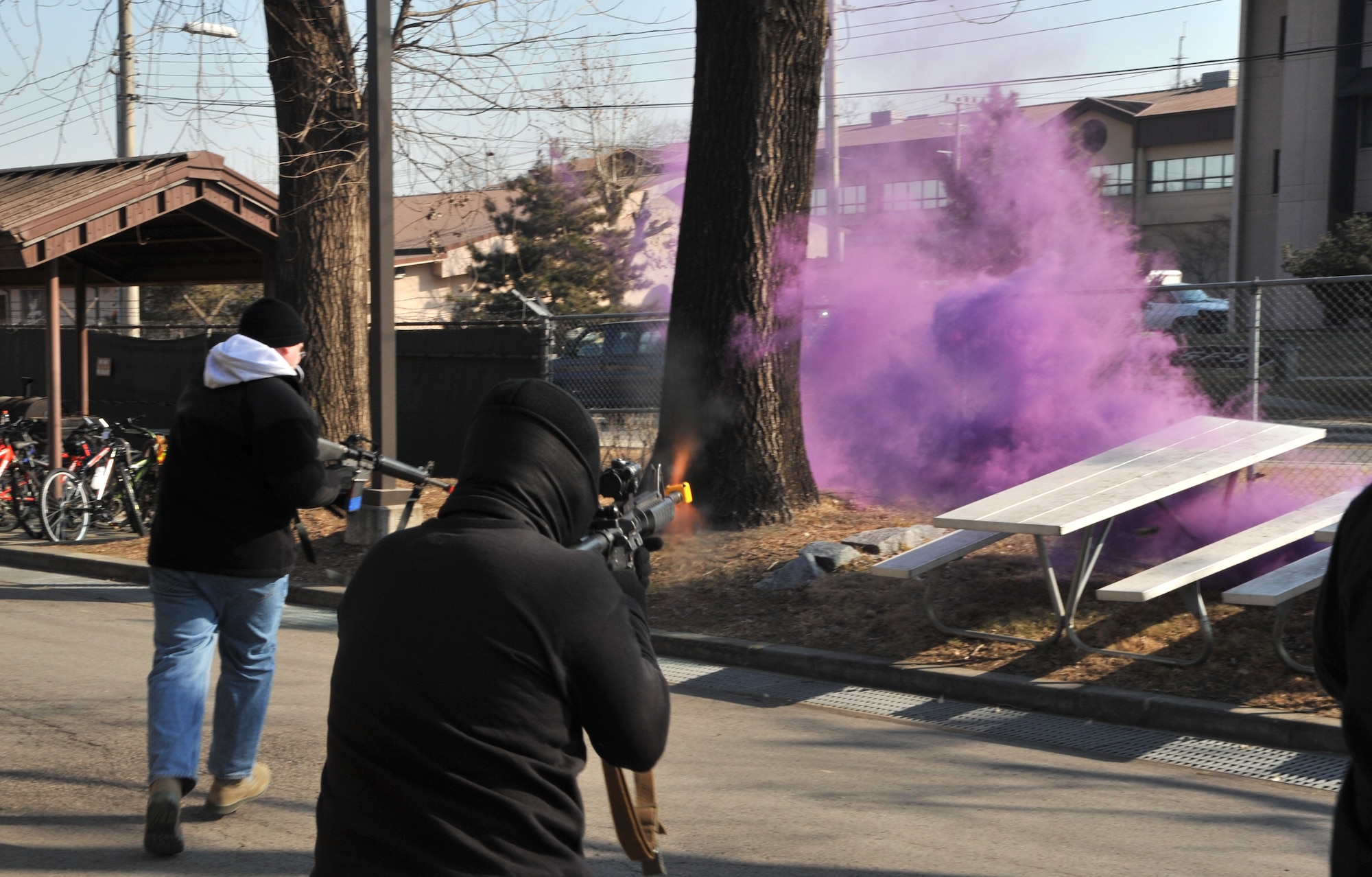 Opposition forces role players engage other Airmen in a mock firefight during a simulated ground attack scenario at the 51st Logistics Readiness Squadron vehicle compound during Operational Readiness Exercise Beverly Midnight 14-01 at Osan Air Base, Republic of Korea, Jan. 14, 2014. The training exercise involved opposition forces infiltrating the secured area, requiring members of the 51st LRS and the 51st Security Forces Squadron to regain control of the compound. (U.S. Air Force photo/Airman 1st Class Ashley J. Thum)