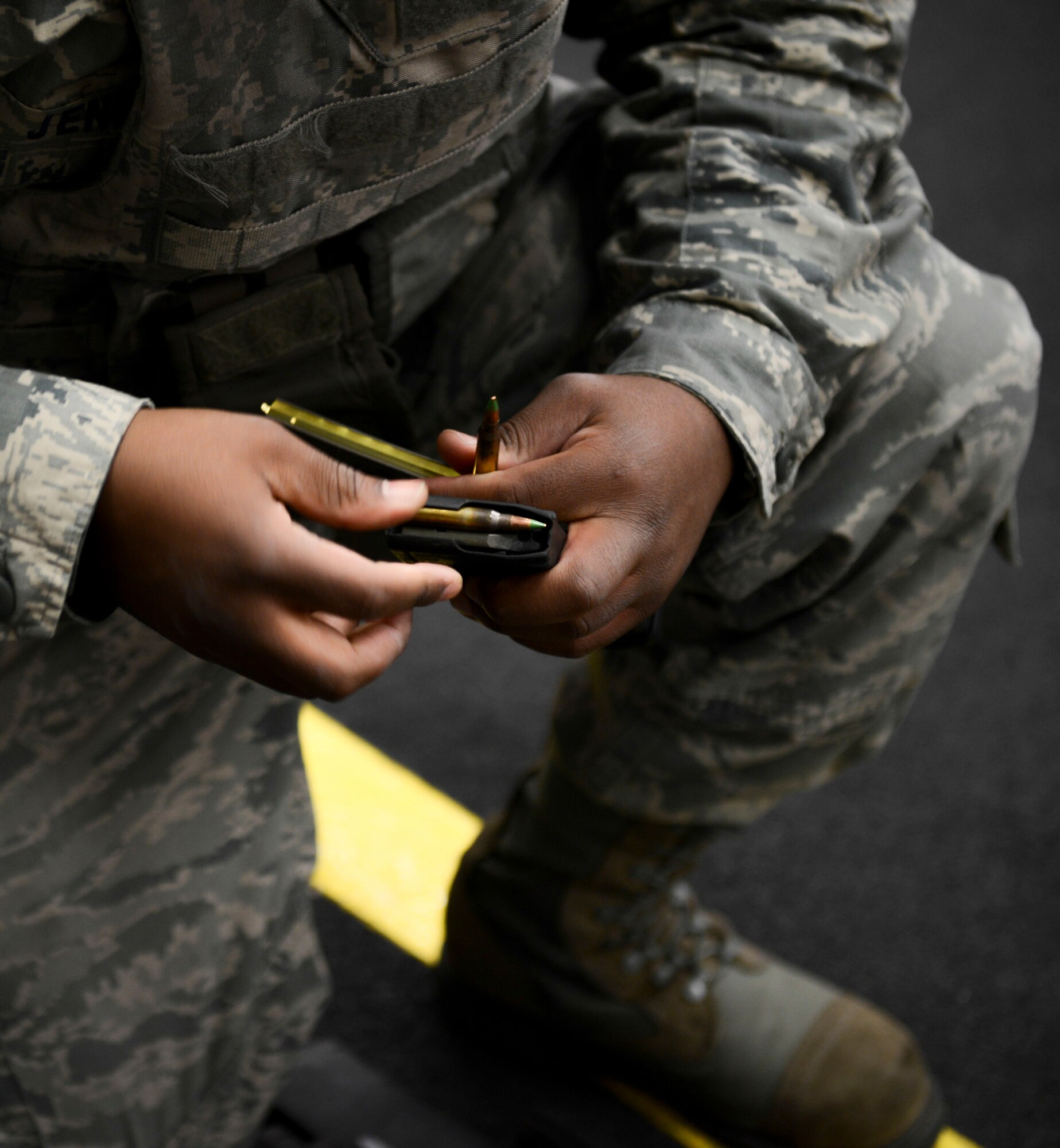 Senior Airman Brandon Jenkins, 374th Logistics Readiness Squadron fuels specialist, loads a magazine at Yokota Air Base, Japan, Jan. 15, 2014.  Airmen train and qualify at Combat Arms so they can deploy. (U.S. Air Force photo by Airman 1st Class Meagan Schutter/Released)