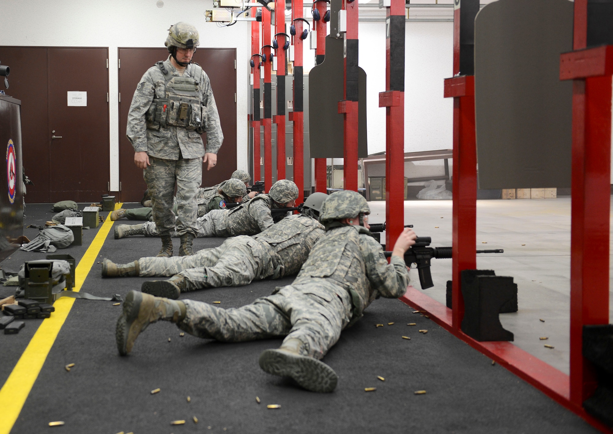 Staff Sgt. Stephen Ceo, 374th Security Forces Squadron combat arms instructor, watches Airmen while they fire at the designated targets at Yokota Air Base, Japan, Jan. 15, 2014.  Before deploying, each Airman trains and qualifies at Combat Arms. (U.S. Air Force photo by Airman 1st Class Meagan Schutter/Released)