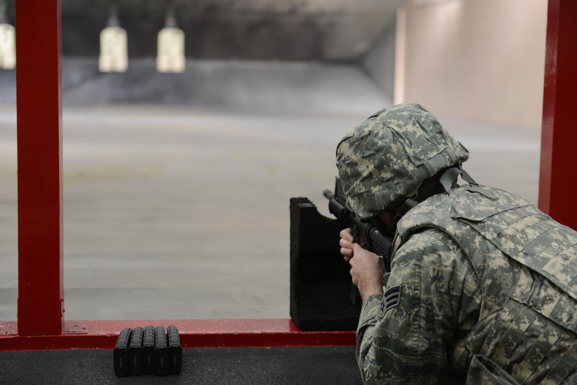 Senior Airman Jacob Haynes, 374th Logistics Readiness Squadron fuels specialist, aims for his target at Yokota Air Base, Japan, Jan. 15, 2014.  Each Airman must successfully complete each round of prone, kneeling and standing positions in order to qualify. (U.S. Air Force photo by Airman 1st Class Meagan Schutter/Released)
