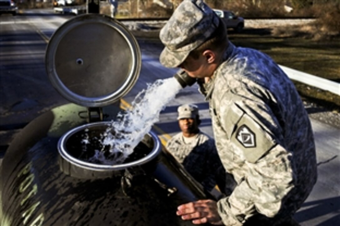 West Virginia National Guardsmen help draw from the water supply at the Summit Bechtel Reserve near Mount Hope, W.Va., Jan 12, 2014, to check for contamination during Operation Elk River. The soldiers are assigned to the 1257th Transportation Company.