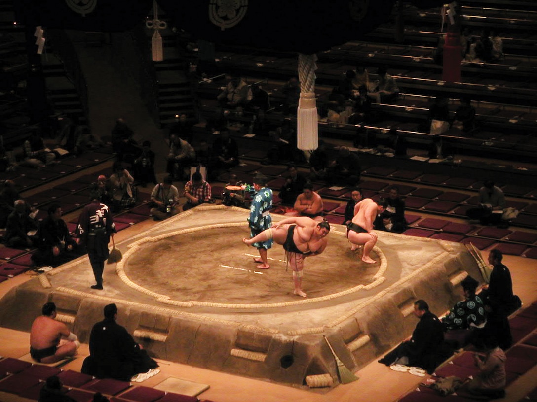 An audience watches Sumo wrestlers, or rikishi, begin a match recently at Tokyo’s Ryogoku Kokugikan Sumo Hall. Before a match, sumo wrestlers execute traditional movements, which are actually ancient rituals.  For example, upon entering the ring, each rikishi will clap their hands as they would at an actual Shinto shrine to get the attention of the deity at that shrine. (U.S. Marine Corps photo by Maj. Giuseppe A. Stavale/Released)
