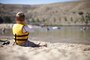 A young man enjoy the buzz around the beach on a hot summer day.  Playing safe around natural waters rests in large part upon lifejackets and close supervision.