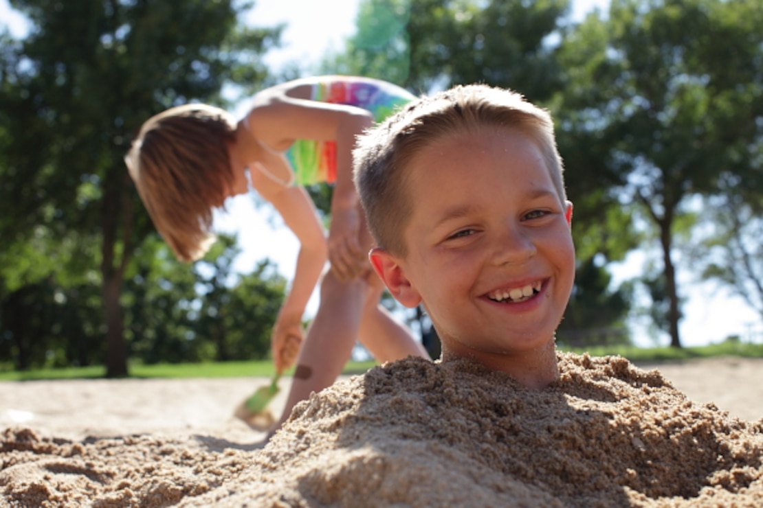 Kids enjoy the cool sand at Lucky Peak State Park’s Sandy Point Unit.
