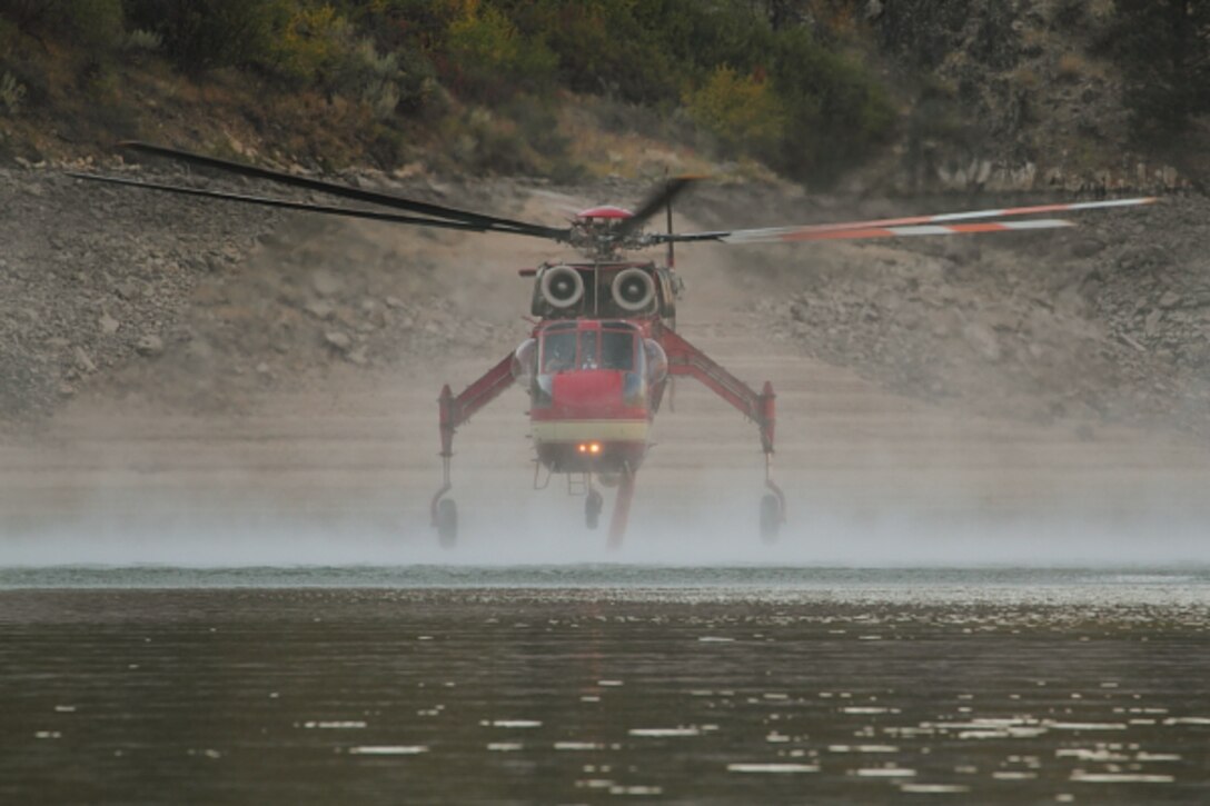 Fire hazards soar every summer around Lucky Peak Lake.  The Corps of Engineers and allied agencies work closely together to facilitate safe helicopter dipping operations from the lake to assist nearby firefights.