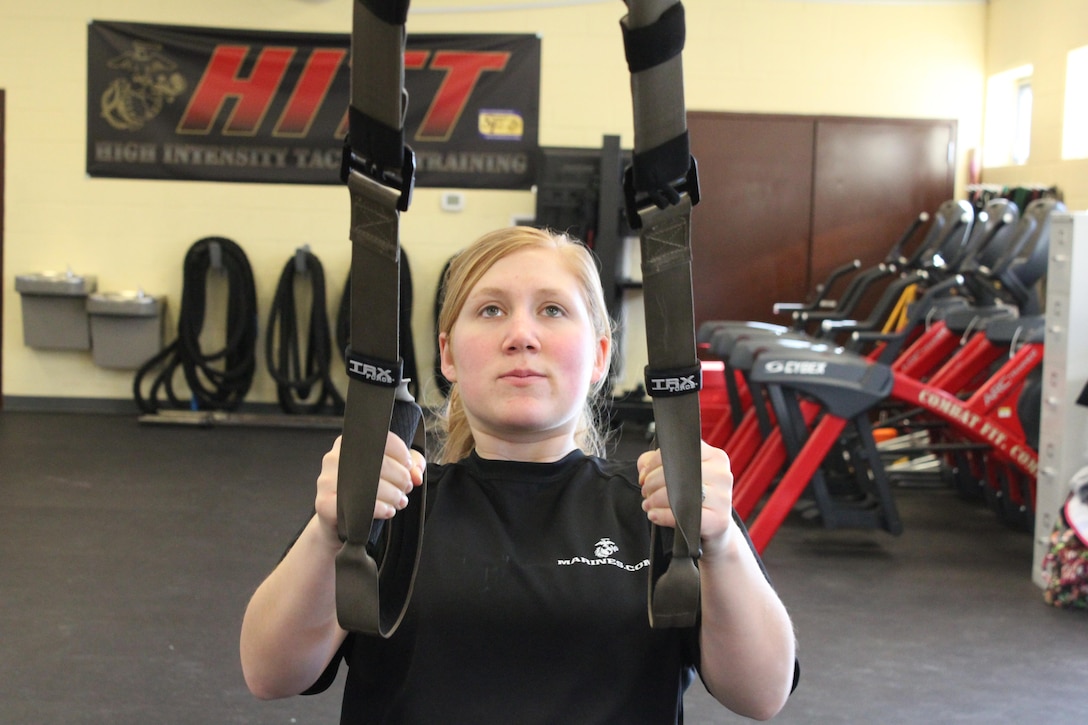 Cpl. Sarah Alsip, a fiscal clerk at the Wounded Warrior Regiment aboard Marine Corps Base Quantico, performs scapula retractions, which helps with the first pull of pull-ups by using a Suspension Training band during Semper Fit’s first pull-up clinic Jan. 7, 2014. The program will offer pull-up progression training on the first Tuesday of every month.  