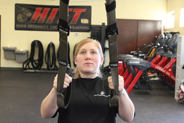 Cpl. Sarah Alsip, a fiscal clerk at the Wounded Warrior Regiment aboard Marine Corps Base Quantico, performs scapula retractions, which helps with the first pull of pull-ups by using a Suspension Training band during Semper Fit’s first pull-up clinic Jan. 7, 2014. The program will offer pull-up progression training on the first Tuesday of every month.  