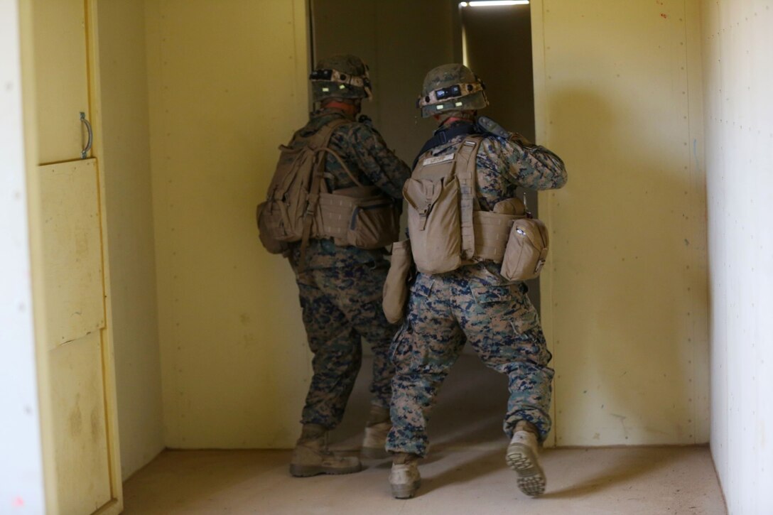 Lance Cpl. Hayden Parker, left, a native of Florence, Ariz., and Lance Cpl. Scott Gropp, a native of Lincoln, Neb., both riflemen, Alpha Company, 1st Battalion, 5th Marine Regiment, practice proper techniques to clear a room during an Urban Operations exercise at Marine Corps Base Camp Pendleton, Calif., Jan. 9, 2014. Each building is designed differently to offer an unpredictable layout that Marines would normally experience in UO. The rooms are filled with distracting elements including holes in the walls, open ceilings and multiple doorways. (U.S. Marine Corps photo by Lance Cpl. Christopher J. Moore/Released)