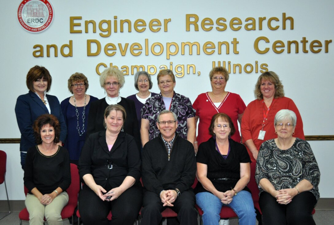 Former Chanute Air Force Base employees who took positions at CERL after the base closed gathered for a photo recently. (Back, l-r) Melissa Suits, Beverly Heiden, Judy Kopmann, Diane Brackemyre, Cathy Breeden, Diane Biggs and Rita Brooks. (Front, l-r) Kendra Little, Toni Gilman, John Mudrick, Sandy Bantz and Kathy Lee.