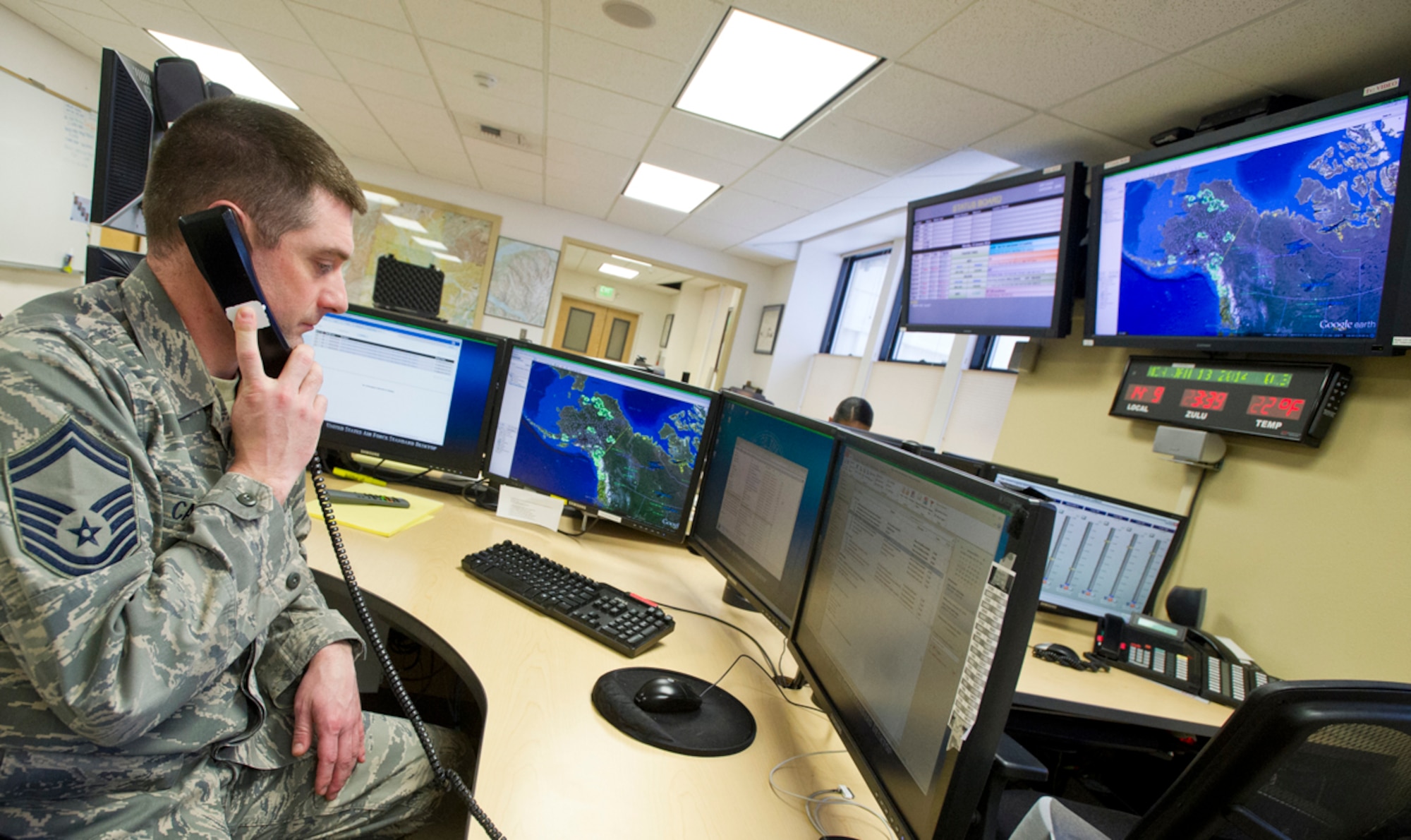 Air Force Senior Master Sgt. Rob Carte, superintendent of the Rescue Coordination Center, dual assigned to the 11th Air Force and 176th Wing of the Alaska Air National Guard, answers a call at his station in the RCC at Joint Base Elmendorf-Richardson, Alaska, Jan. 13, 2014. There are only two RCC's in the United States Air Force-one at JBER, Alaska, under the 11th Air Force, and one at Tindall Air Force Base, Fla., under the 1st Air Force. (U.S. Air Force photo by Justin Connaher/Released)