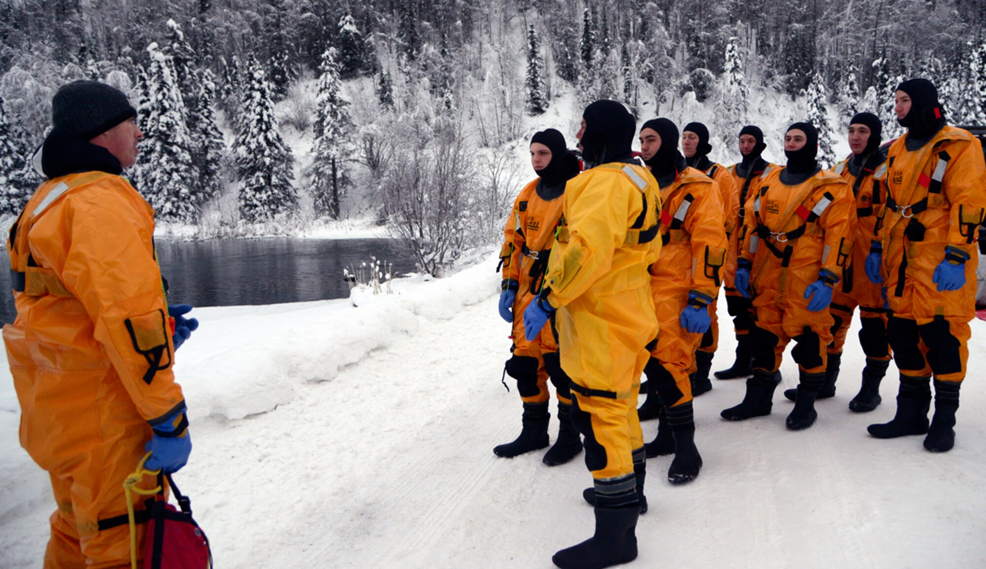Louis Larousse, 673d Civil Engineer Squadron firefighter, conducts a safety brief prior to jumping into a partially frozen lake at Joint Base Elmendorf-Richardson, Alaska, Jan. 13, 2014. The firefighters train their staff annually to stay proficient in ice water rescue since Alaska lakes are froze nine to 10 months of the year. (U.S. Air Force photo/Staff Sgt. Sheila deVera)