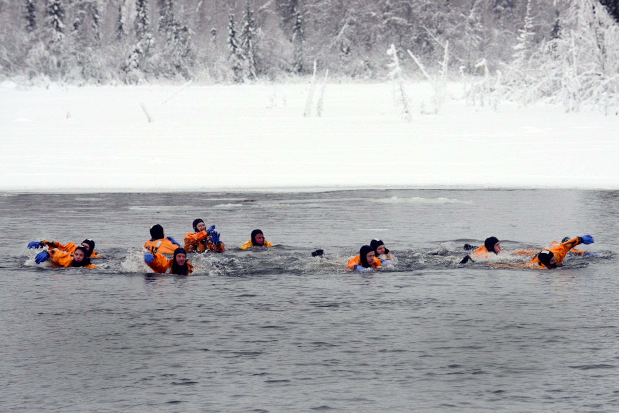 Firefighters from the 673d Civil Engineer Squadron swim across Upper Sixmile Lake while conducting ice water rescue training in 14-degree weather Jan. 13, 2014 at Joint Base Elmendorf-Richardson, (U.S. Air Force photo/Staff Sgt. Sheila deVera)