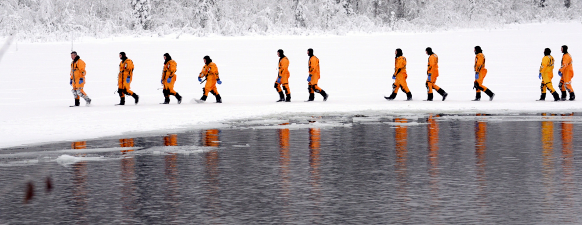 The 673d Civil Engineer Squadron firefighters walk in a single-line formation after completing the first phase of ice water rescue training Jan. 13, 2014 at Joint Base Elmendorf-Richardson, Alaska. 