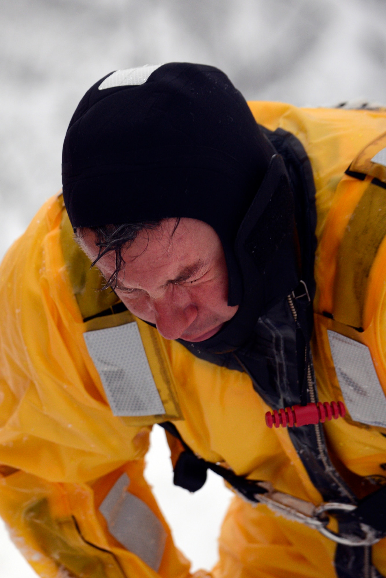 Dale Reierson, 673d Civil Engineer Squadron firefighter, catches his breath after completing the first phase of ice water rescue training at Upper Sixmile Lake, Joint Base Elmendorf-Richardson, Alaska, Jan. 13, 2014. JBER firefighters are first responders providing protection to people, property, and the environment from fires and disaster, rescue and hazardous material responses. (U.S. Air Force photo/Staff Sgt. Sheila deVera)