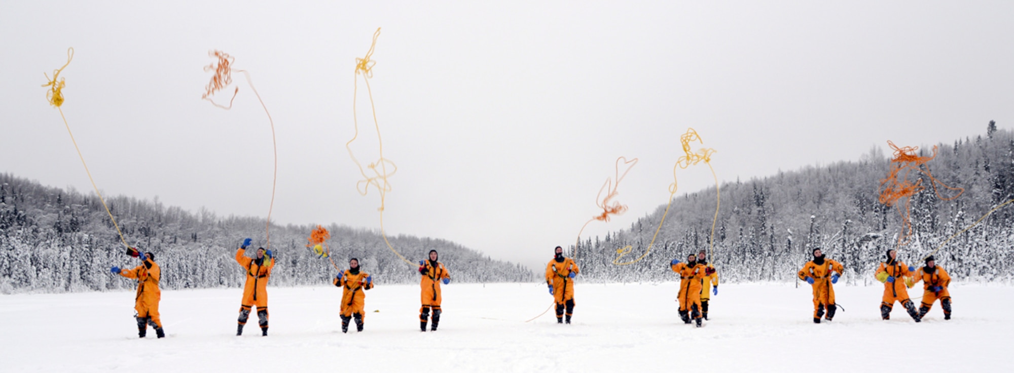 Firefighters from the 673d Civil Engineer Squadron perform rope-throw operations using a throw bag at Upper Sixmile Lake, Joint Base Elmendorf-Richardson, Alaska, Jan. 13, 2014. The rope throw is the primary rescue operation for ice water rescues and one of the most versatile tools used for water rescue. (U.S. Air Force photo/Staff Sgt. Sheila deVer)