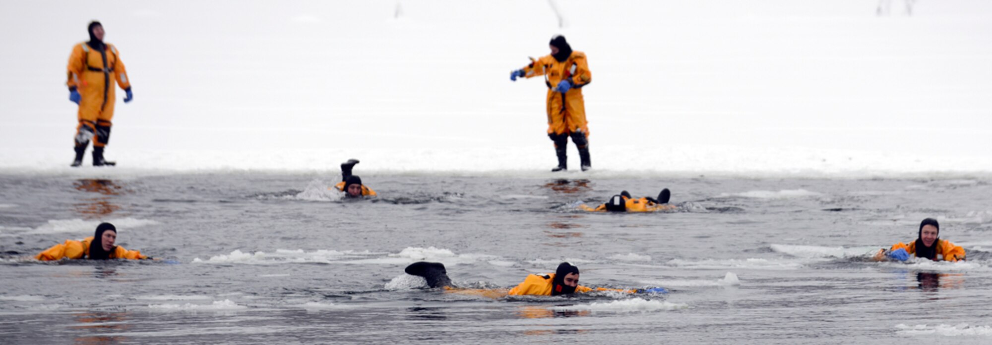 Firefighters from the 673d Civil Engineer Squadron swim across Upper Sixmile Lake while conducting ice water rescue training in 14-degree weather at Joint Base Elmendorf-Richardson, Jan. 13, 2014. (U.S. Air Force photo/Staff Sgt. Sheila deVera)

