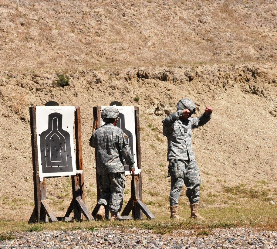 Members of Joint Task Force-Bravo fire M9 pistols at targets 25 meters away as part of the German Armed Forces Proficiency Badge Qualification test at Soto Cano Air Base, Honduras, Jan. 14, 2014.  Forty members of Joint Task Force-Bravo earned the badge over three days of testing.  (Photo by Ana Fonseca)
