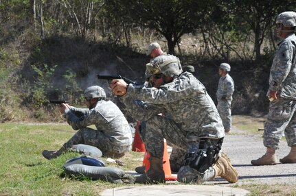 Members of Joint Task Force-Bravo fire M9 pistols at targets 25 meters away as part of the German Armed Forces Proficiency Badge Qualification test at Soto Cano Air Base, Honduras, Jan. 14, 2014.  Forty members of Joint Task Force-Bravo earned the badge over three days of testing.  (Photo by Ana Fonseca)