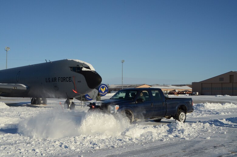 Members of the 126th Maintenance Group plow out a snow bound KC-135R Stratotanker on the parking ramp of the 126th Air Refueling Wing's facilities at Scott Air Force Base, Ill., January 7, 2014. The Illinois Air National Guard unit maintains a fleet of aerial refueling aircraft capable of in-flight refueling for Department of Defense and allied aircraft. (Air National Guard photo by Master Sgt. Ken Stephens)