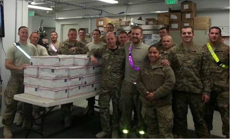 Members of the 432nd Aircraft Maintenance Squadron receive 54 care packages
Dec. 12 while deployed overseas. The packages contained more than 1,000
items, which were collected, donated and shipped by Creech Airmen. (courtesy photo)