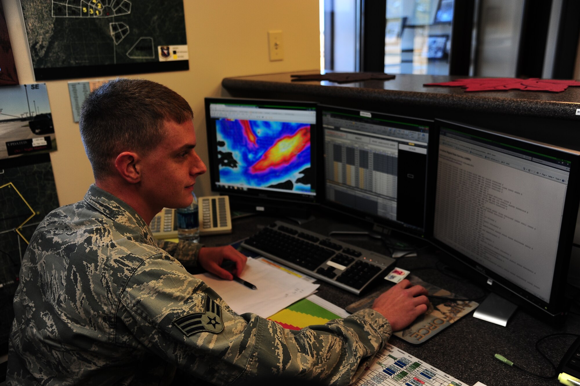 Senior Airman Ian Lorenz, 14h Operations Support Squadron, scans weather monitors for important information. The information Lorenz collects helps keep out pilots safe from the drastic changes in the weather. (U.S. Air Force Photo/Airman 1st Class Daniel Lile)