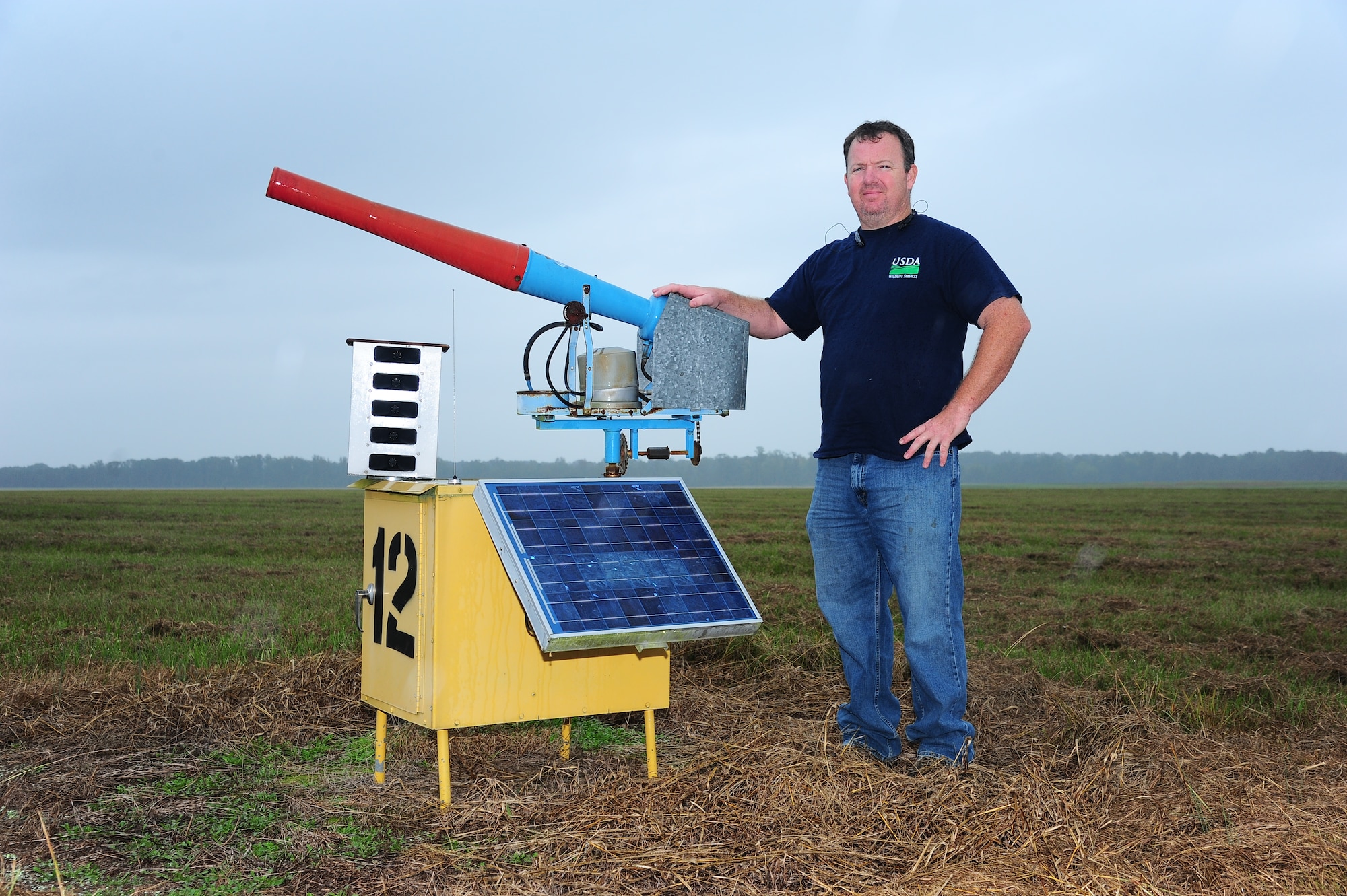Buck Jolley, 14th Flying Training Wing Safety Office and a Wildlife Biologist on Columbus Air Force Base, stands by a propane cannon on the flight line. Propane cannons are used to scare away birds that could be dangerous to our aircraft. (U.S. Air Force Photo/ Airman 1st Class Daniel Lile)