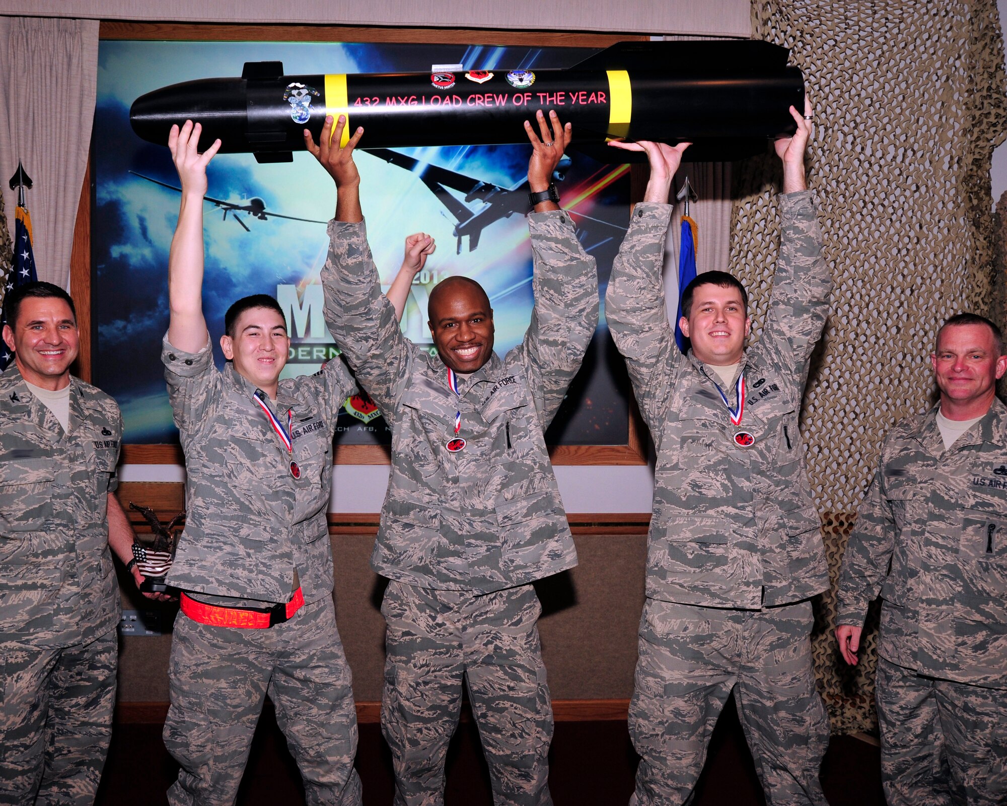 Members of the 432nd Maintenance Group celebrate the group’s accomplishments during the 2013 Maintenance Professional of the Year banquet March 16 at Nellis Air Force Base. (U.S. Air Force Photo by Tech. Sgt. S.E.)