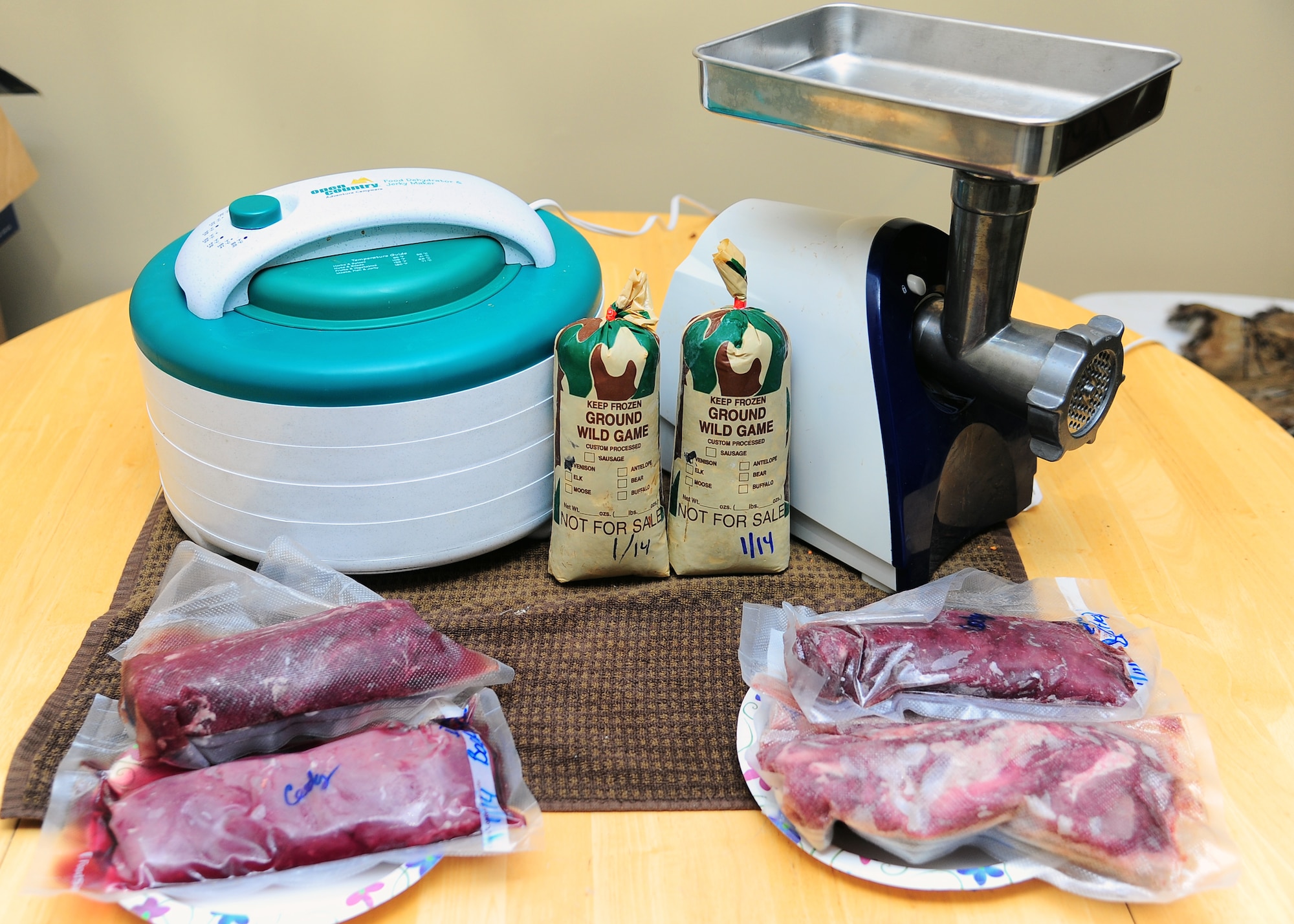 Tools used for processing meat including a meat grinder, dehydrator and a butcher’s knife. Everything a new hunter needs to harvest their animals independently. (U.S. Air Force Photo/Airman 1st Class Daniel Lile)