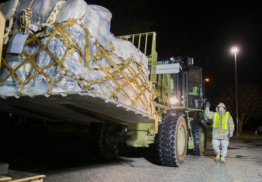 U.S. Air Force Senior Airman Steven Tepperberg, 23d Communications Squadron radar maintenance journeyman, directs a forklift operator at Moody Air Force Base, Ga., Jan. 14, 2014. Tepperberg and a team of Airmen weighed and logged each pallet as part of a wing-wide exercise. (U.S. Air Force photo by Airman 1st Class Ryan Callaghan/Released)
