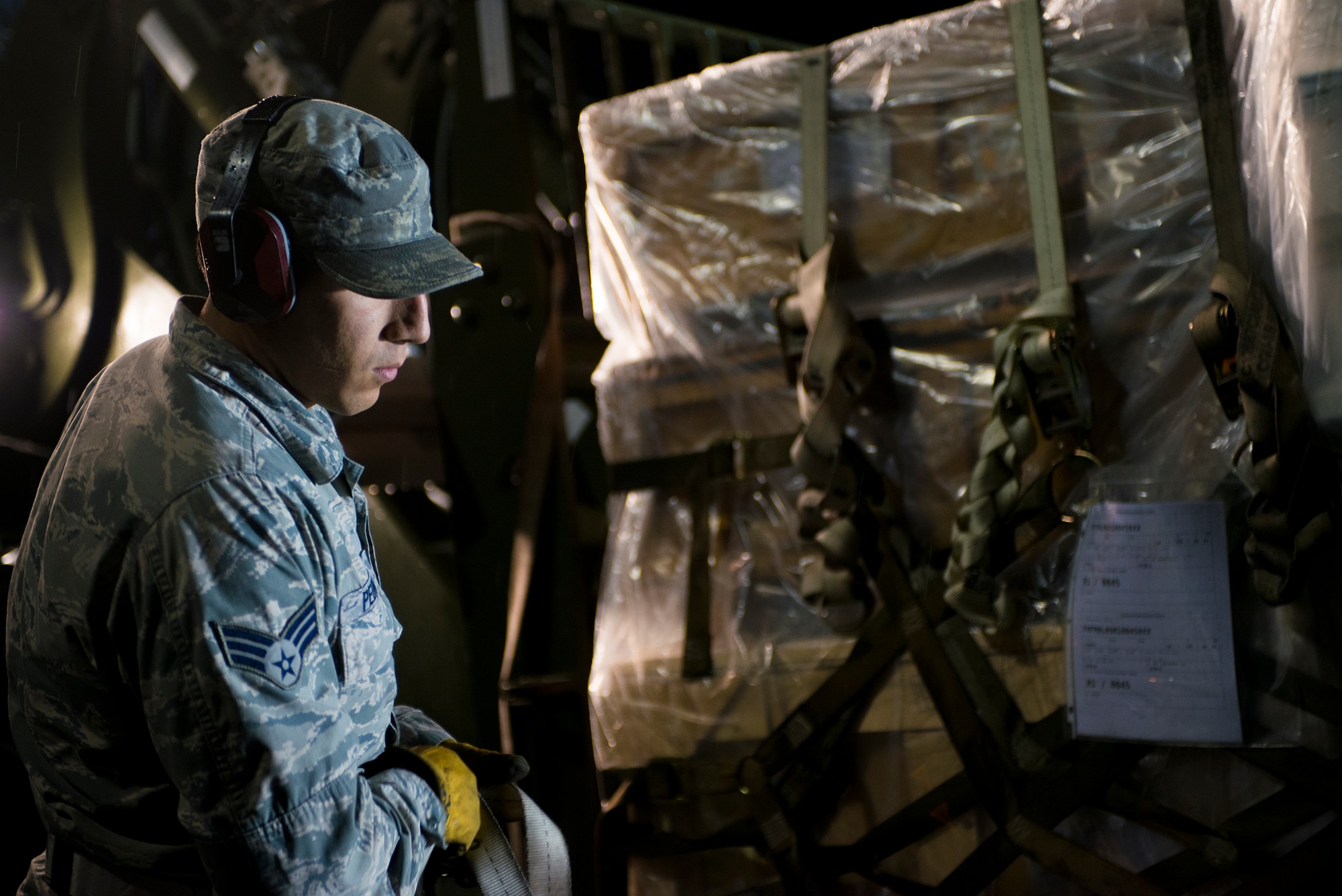 U.S. Air Force Senior Airman Sal Pedraza, 23d Logistics Readiness Squadron vehicle operator, begins removing a pallet from a forklift at Moody Air Force Base, Ga., Jan. 14, 2014. Pedraza and a team of Airmen worked through the night to weigh cargo pallets for Moody’s first wing readiness inspection. (U.S. Air Force photo by Airman 1st Class Ryan Callaghan/Released)
