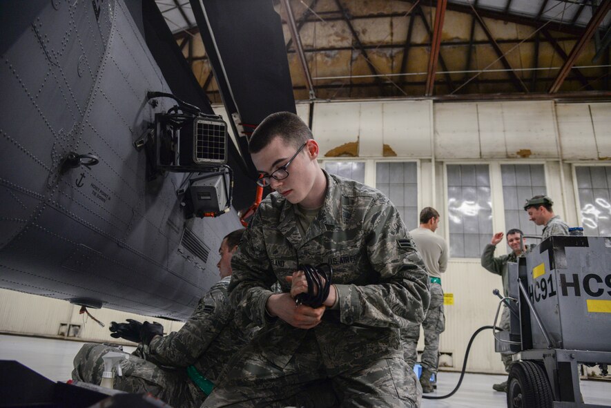 U.S. Air Force Airman 1st Class Jacob Eveland, 723d Aircraft Maintenance Squadron crew chief, gathers equipment after helping Airmen with soldering on an HH-60G Pave Hawk during a Wing Readiness Exercise at Moody Air Force Base, Ga., Jan. 14, 2014.  The maintainers prepped the HH-60 to demonstrate their pre-deployment capabilities. (U.S. Air Force photo by Airman 1st Class Sandra Marrero/Released)