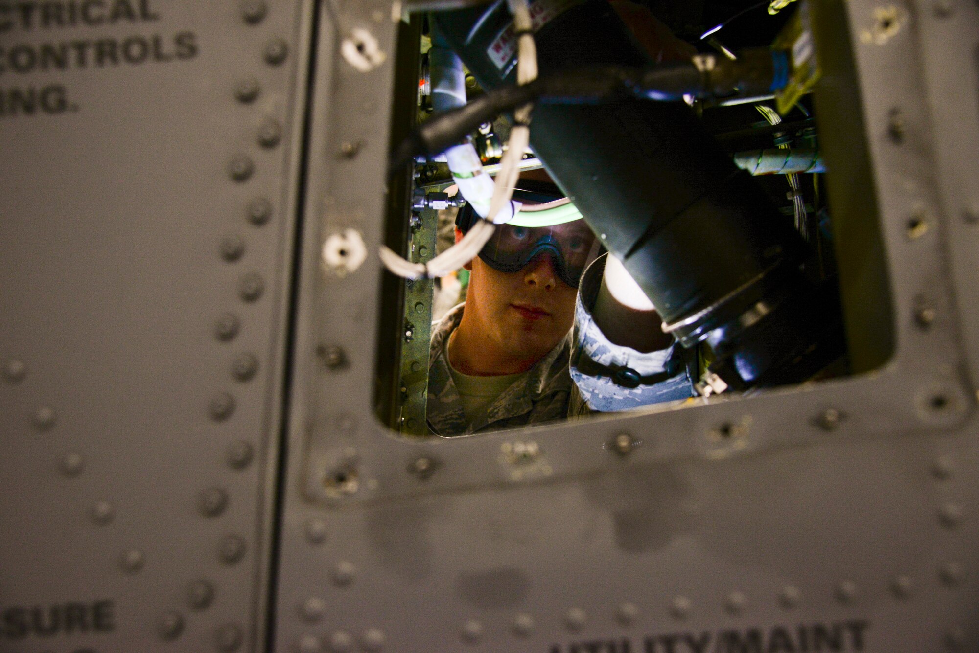 U.S. Air Force Airman 1st Class Benjamin Taylor, 723d  Aircraft Maintenance Squadron crew chief, services a strut on an HH-60G Pave Hawk during a Wing Readiness Exercise at Moody Air Force Base, Ga., Jan. 14, 2014. The maintainers prepared the HH-60 for transport on a C-17 Globemaster III during Moody’s first WRI. (U.S. Air Force photo by Airman 1st Class Sandra Marrero/Released)
