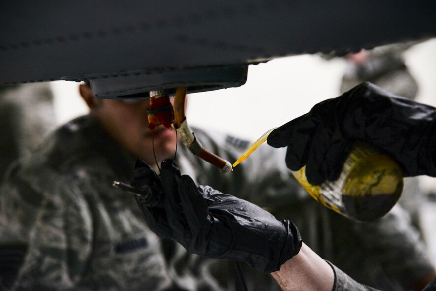 U.S. Air Force Airman 1st Class Kevin McGraw, 723d Aircraft Maintenance Squadron crew chief, prepares an HH-60G Pave Hawk’s radio frequency connector for soldering during a Wing Readiness Inspection, Jan. 14, 2014  Moody Air Force Base, Ga. The RF connector is hooked to an antenna that is used for aircraft navigation. (U.S. Air Force photo by Airman 1st Class Sandra Marrero/Released) 