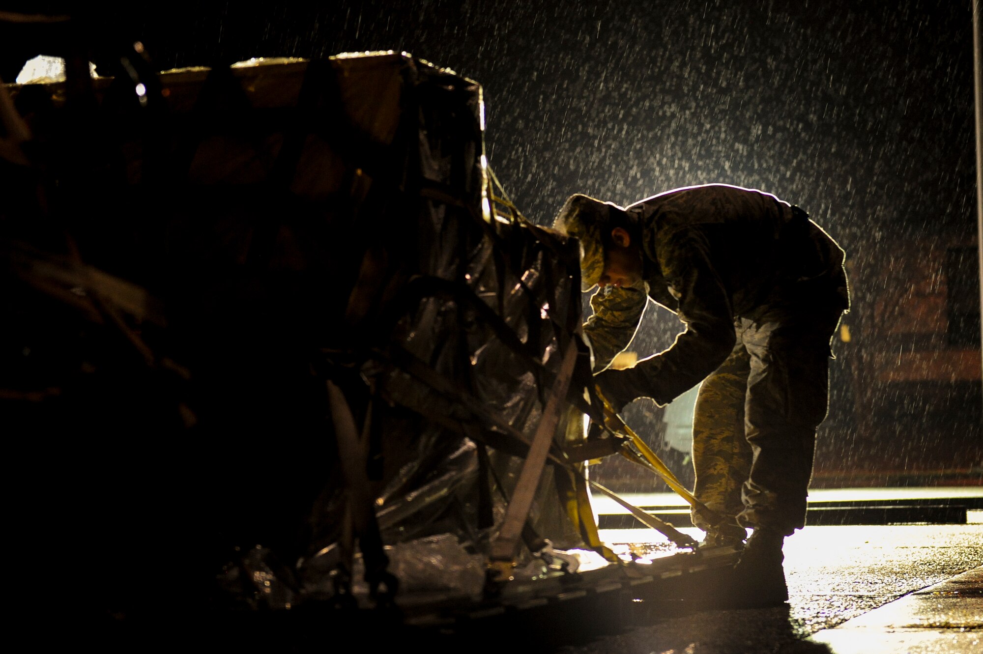 U.S. Air Force Airman 1st Class Shane Steele, 723d Aircraft Maintenance Squadron crew chief, secures a cargo pallet during a wing readiness inspection at Moody Air Force Base, Ga., Jan. 14, 2014. Steele preps and stages the cargo in a holding area prior to it being loaded onto an aircraft. (U.S. Air Force photo by Tech. Sgt. Joshua J. Garcia/Released)