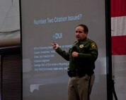 Sergeant Duane Ellis, Wyoming State Highway Patrol, speaks to an audience of 90th Missile Wing Airmen during a 90th MW DUI stand-down in Bldg. 1501 Jan. 15, 2014. Ellis addressed driving issues the highway patrol noted among the F.E. Warren and Wyoming populations such as speeding, distracted driving and impaired driving. Stand-down coordinators invited Ellis to speak. (U.S. Air Force photo by Airman 1st Class Jason Wiese)