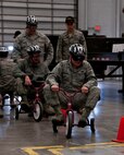 Capt. Stephen Hodgson, 90th Force Support Squadron, rides a tricycle through a slalom of cones wearing goggles simulating the impairing effects of alcohol on someone’s motor skills during a 90th Missile Wing DUI stand-down in Bldg. 1501 Jan. 15, 2014. The exercise showed alcohol’s debilitating effects and was intended to discourage driving under the influence of alcohol. (U.S. Air Force photo by Airman 1st Class Jason Wiese)