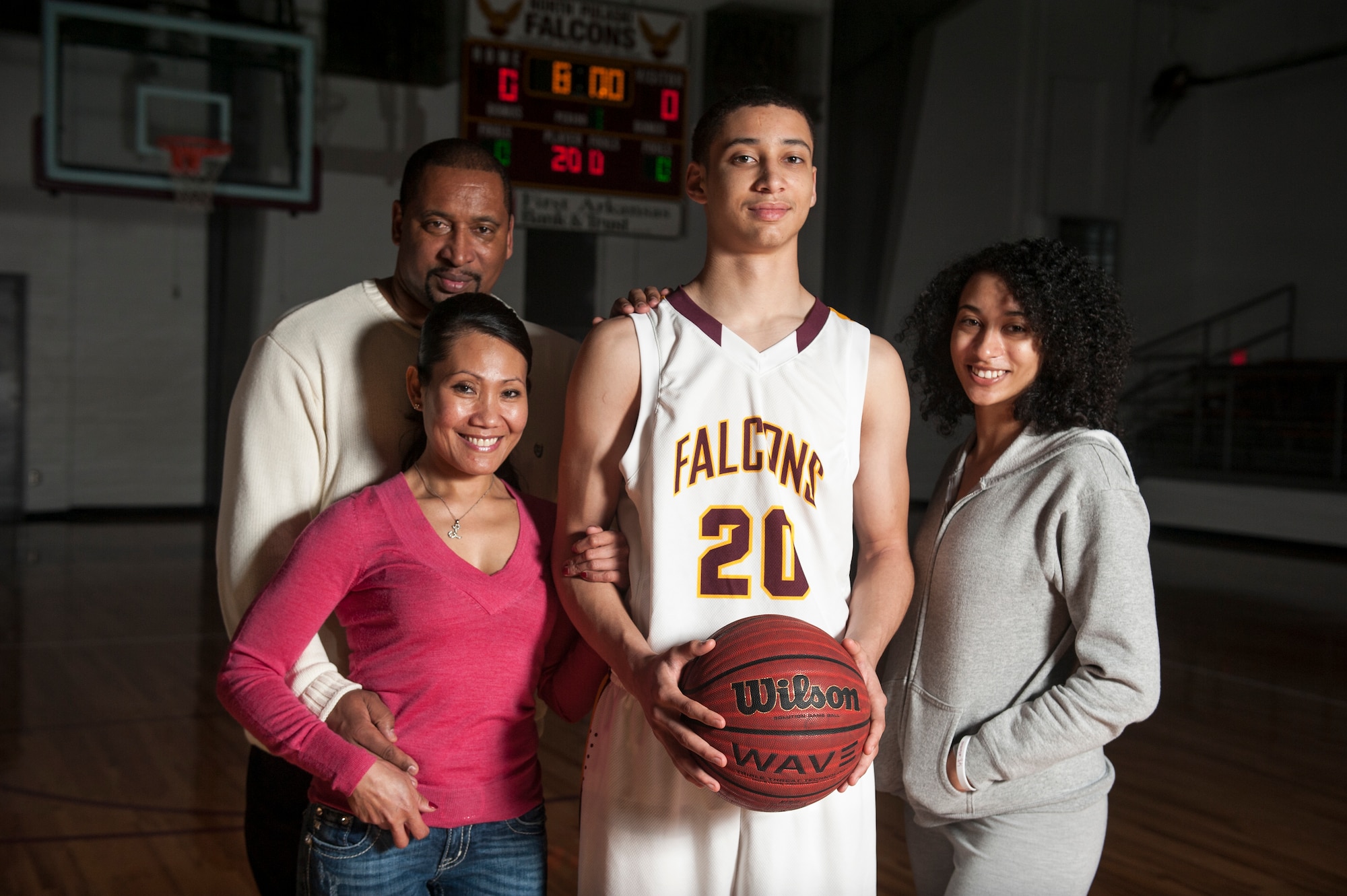 Joseph Aikens, a North Pulaski Falcons point guard is shown here with his father (left) James Aikens, stepmother (left) Lourdes Aikens, and sister (right) Jessica Aikens. Aikens hopes to become a pilot after attending the U.S. Air Force Academy. Aikens, son of retired Air Force Master Sgt. James Aikens, has only had two dreams growing up; playing Division I basketball and becoming a pilot. (U.S. Air Force photo by Airman 1st Class Cliffton Dolezal)