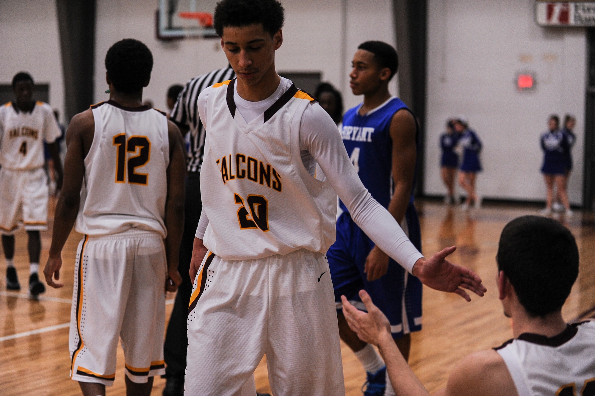 A teammate congratulates Joseph Aikens, a North Pulaski Falcons point guard, as he heads to the bench late in the fourth quarter of a game Nov. 26, 2013, at North Pulaski High School. Aikens has always wanted to play Division I basketball and after receiving an appointment to play for the U.S. Air Force Academy he will finally have a chance. (U.S. Air Force photo by Airman 1st Class Cliffton Dolezal) 