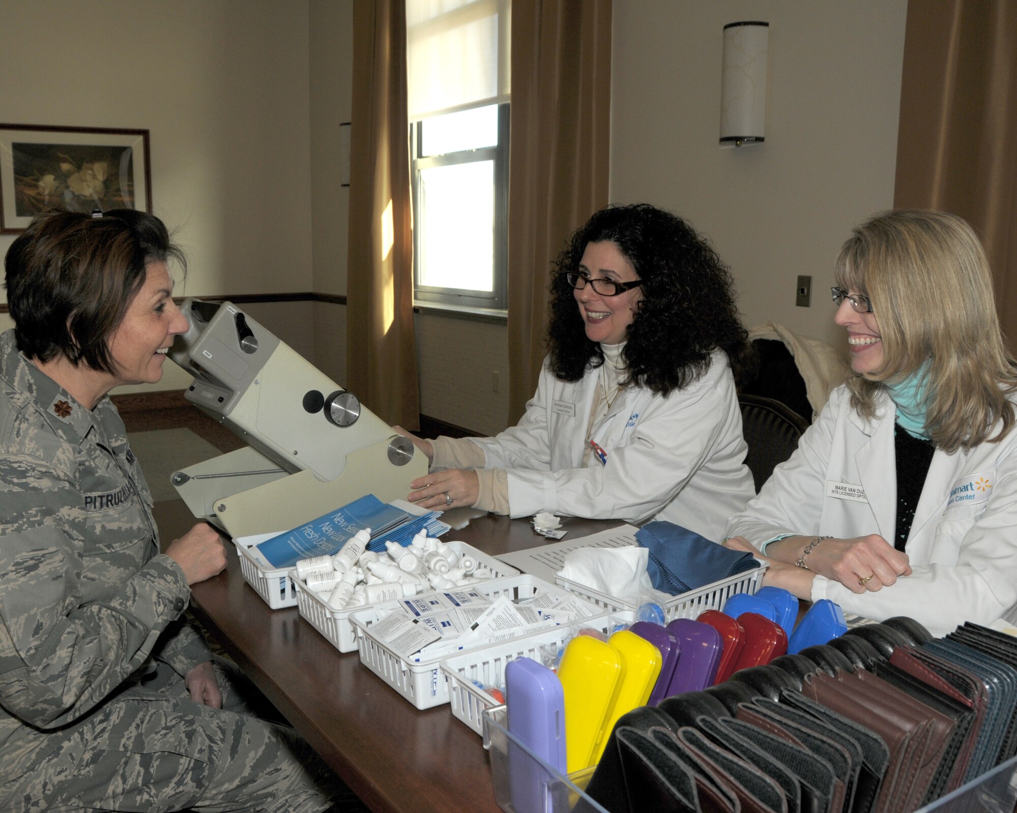 Maj. Andrea Pitruzzella (left), Chief of 914th Airlift Wing Public Affairs chats with Ann Marie Szdnoky and Marie VanDozer, opticians from Walmart Vision about the services they provide on January 15, 2013 at the Niagara Falls Air Reserve Station, NY. Approximately 30 vendors were on hand at the Get Fit Wellness Seminar which was held at the Niagara Heritage Center. Some of the vendors offered information on bone density screening, smoking cessation, glucose/BMI screening, animal therapy and more. (U.S. Air Force photo by Peter Borys)