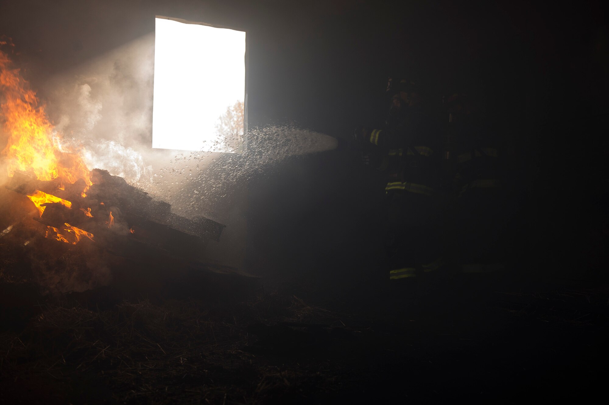 Fire fighters from the 19th Airlift Wing extinguish a fire Nov. 30, 2013, at Little Rock Air Force Base, Ark. The fire was part of a quarterly training event required by the Air Force to keep firefighters proficient in fire fighting techniques. (U.S. Air Force photo by Tech. Sgt. Russ Scalf)
