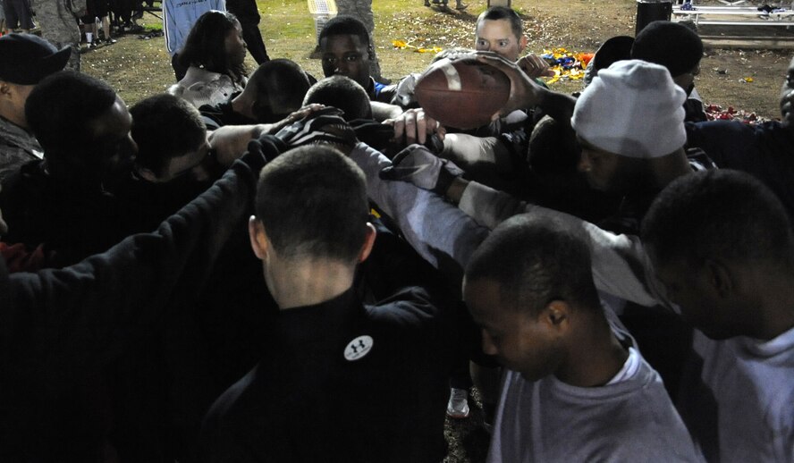 The 2nd Security Forces Squadron gives a final cheer during the intramural flag football championship on Barksdale Air Force Base, La., Jan. 13, 2014. The 2nd SFS defeated the 2nd Aircraft Maintenance Squadron 13-0 in the final game to win the title. (U.S. Air Force photo/ Staff Sgt. Sean Martin)