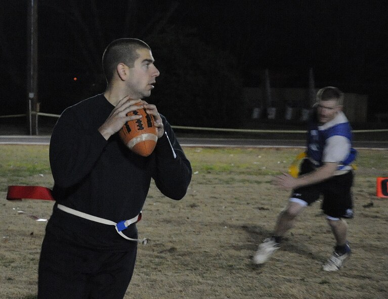 Airman 1st Class Joshua Watson, 2nd Aircraft Maintenance Squadron quarterback, looks for an open receiver during the intramural flag football championship on Barksdale Air Force Base, La., Jan. 13, 2014. The 2nd AMXS was coming into the final game against the 2nd Security Forces Squadron with one loss which meant they had to defeat the 2nd SFS twice in order to be crowned the champions. (U.S. Air Force photo/ Staff Sgt. Sean Martin)