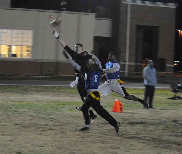 Airman 1st Class Derek Worley, 2nd Aircraft Maintenance Squadron wide receiver, reaches for pass during the intramural flag football championship on Barksdale Air Force Base, La., Jan. 13, 2014. The 2nd AMXS defeated the 2nd Security Forces Squadron in game one of the championship, forcing a sudden death game. The 2nd SFS was able to pull out the win in that game giving them the title. (U.S. Air Force photo/ Staff Sgt. Sean Martin)