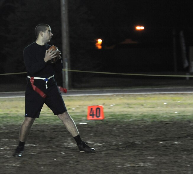 Airman 1st Class Joshua Watson, 2nd Aircraft Maintenance Squadron quarterback, looks for an open receiver during the intramural flag football championship on Barksdale Air Force Base, La., Jan. 13, 2014. The 2nd AMXS defeated the 2nd Operations Support Squadron 19-12 to make it to the championship game. (U.S. Air Force photo/ Staff Sgt. Sean Martin)