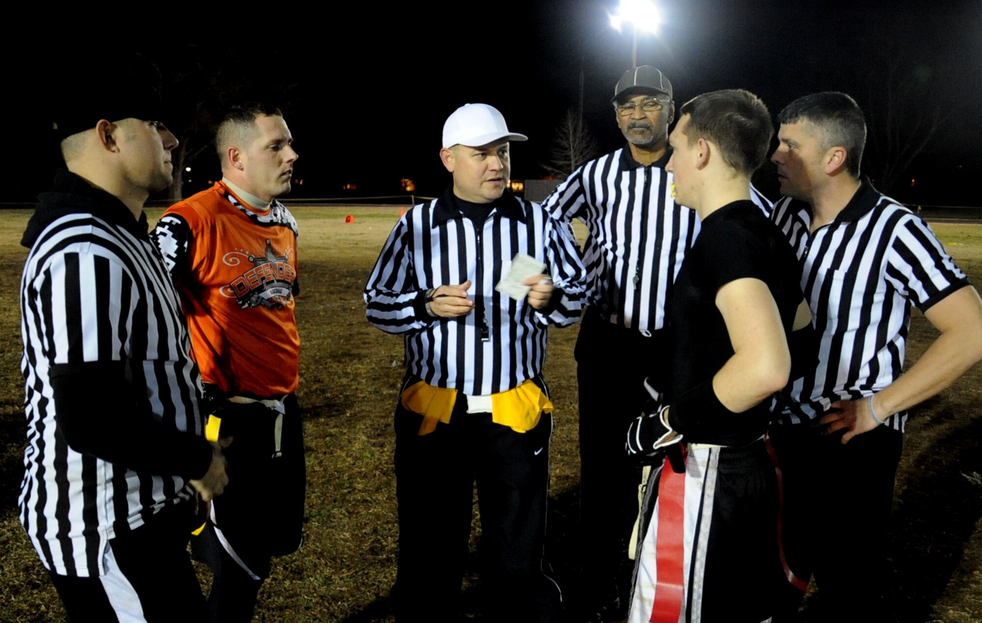 Master Sgt. David Patch, center, 2nd Logistics Readiness Squadron head referee, goes over the rules during the intramural flag football championship on Barksdale Air Force Base, La., Jan. 13, 2014.  The game was played between the 2nd Security Forces Squadron and the 2nd Aircraft Maintenance Squadron. The 2nd SFS won the championship for the fifth straight time. (U.S. Air Force photo/ Staff Sgt. Sean Martin)